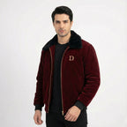 Front view of men's maroon velvet winter jacket featuring a black faux fur collar and gold "D" embroidery, worn over a black t-shirt.