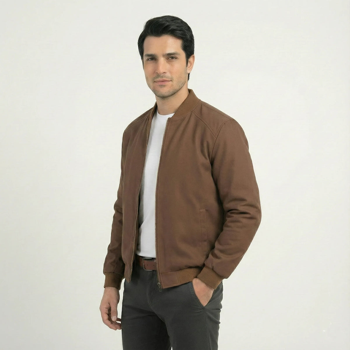 Side angle view of men's brown softshell bomber jacket worn open, showing fit and sleeve length.