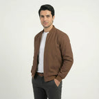 Side angle view of men's brown softshell bomber jacket worn open, showing fit and sleeve length.