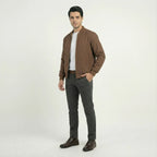 Side angle view of men's brown softshell bomber jacket worn open, showing fit and sleeve length.