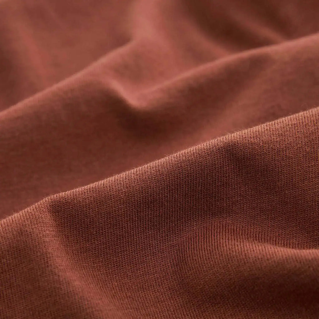 Man wearing a plain brown cotton T-shirt with round neck – front view
