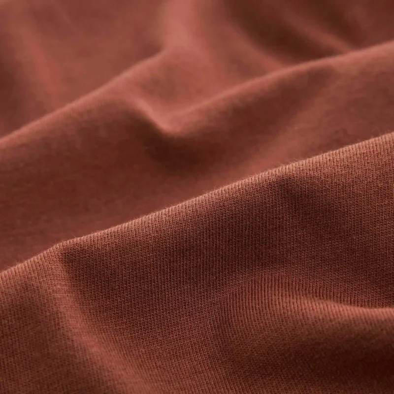 Man wearing a plain brown cotton T-shirt with round neck – front view