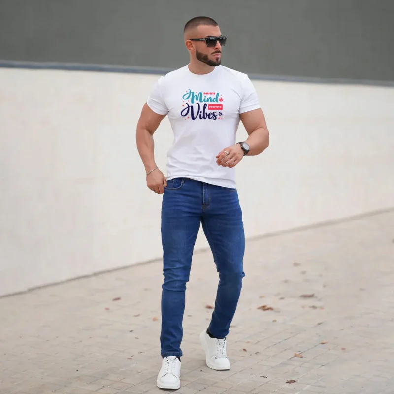 Man wearing a white T-shirt with “Positive Mind Positive Vibes” graphic print