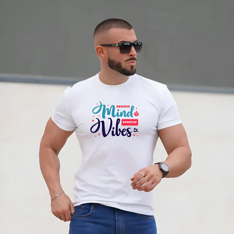 Man wearing a white T-shirt with “Positive Mind Positive Vibes” graphic print